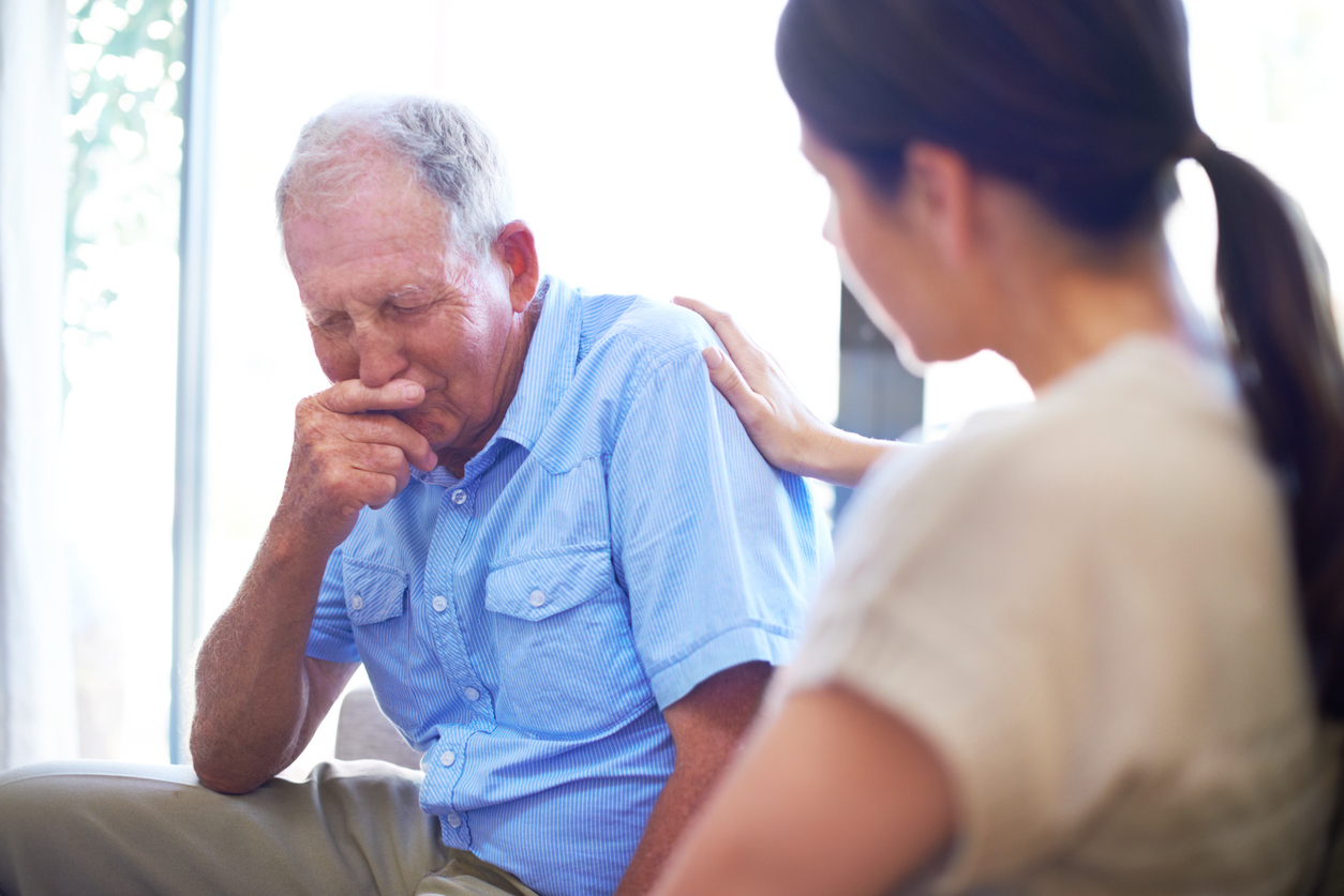 depressed senior man with caregiver